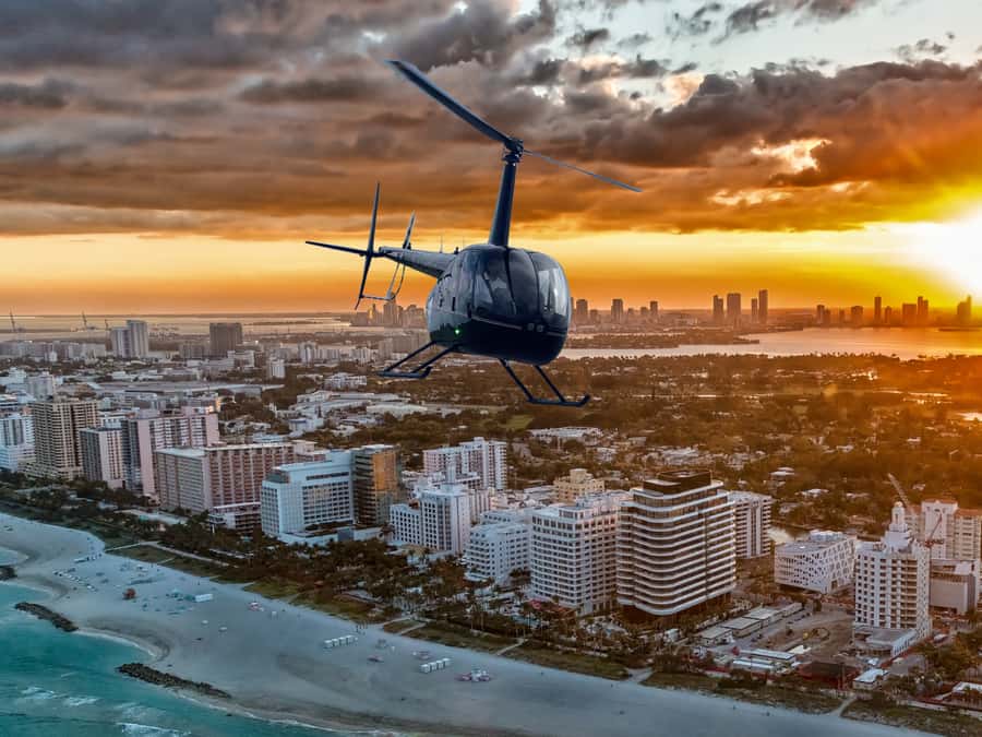 Miami: Private Sunset Helicopter Tour - Taking Off at Miami Executive Airport in a Black-and-Gold R44